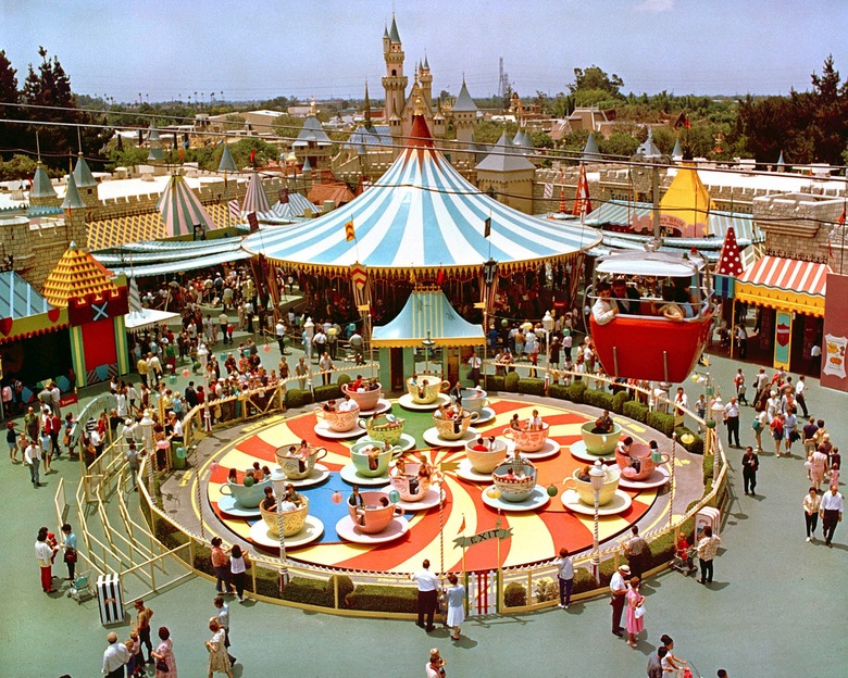 MAD TEA PARTY (1966) -- This opening day attraction, based on a scene in "Alice in Wonderland," spins Disneyland guests in giant teacups.  Pictured here at its original location, it was moved near the Matterhorn in 1983 during the construction of the new Fantasyland.